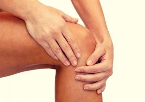 11201847 close up of female hands holding knee2